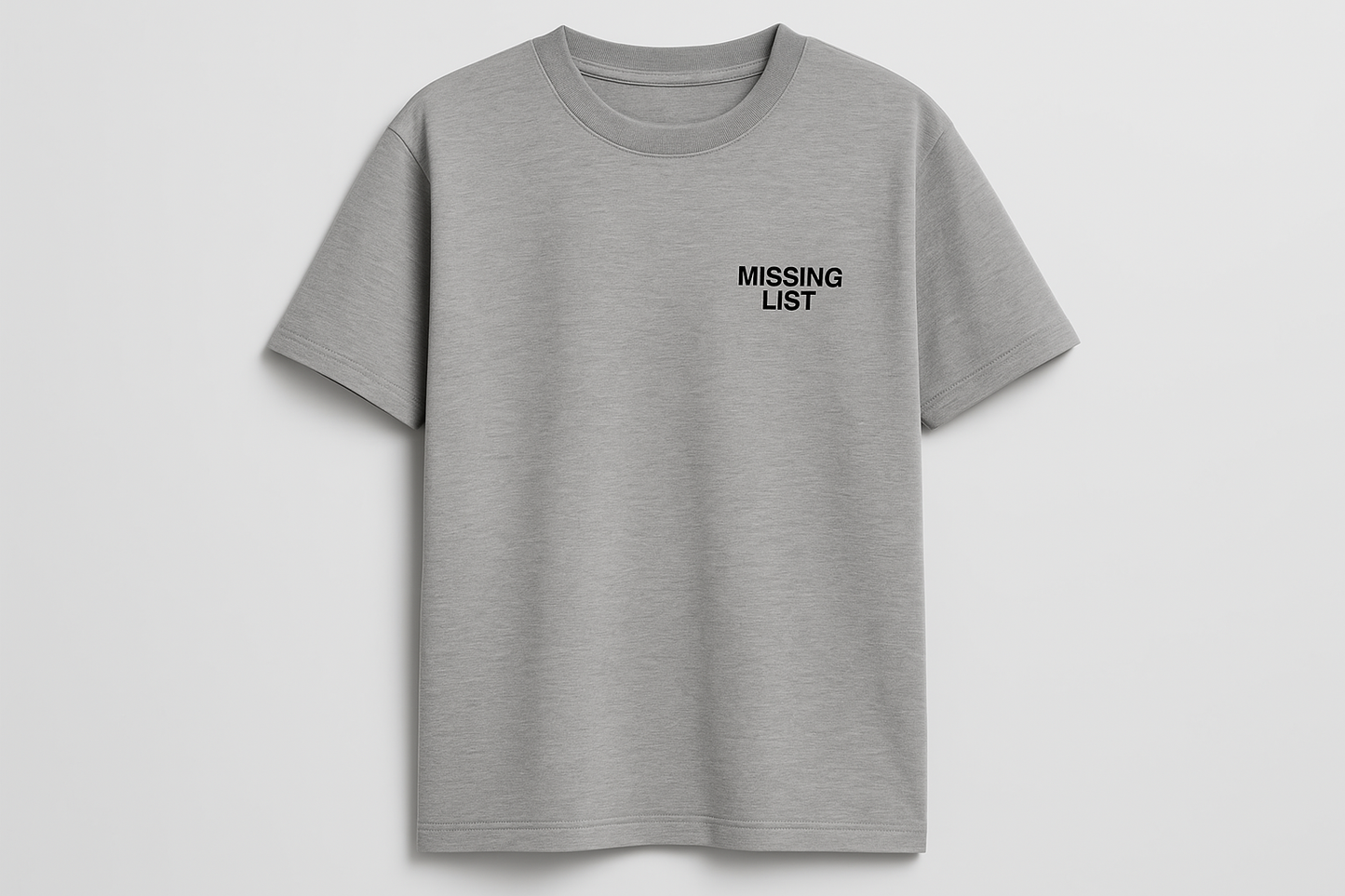 Grey t-shirt with small Missing List logo on left chest on studio background